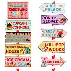 there are many different signs hanging from the ceiling in front of each other, including donuts and shops