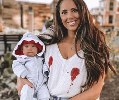 a woman holding a baby in her arms