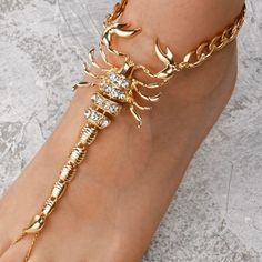 Make A Statement In This Beautiful Rhinestone Scorpian Anklet. Stand Out In This Anklet Along With The Matching Necklace & Body Jewelry Also Sold In This Shop. Who Doesn't Like A Good Statement Piece, I Know I Do! So Make This Beautiful Piece Yours Or Gift A Friend Or Family Member Now While U Can, There's Only A Few Left In Stock. Material Color: Gold Material: Metal Leg Chains Jewelry, Body Jewelry Chains Gold, Shiny Body Jewelry, Body Jewelry Nude, Gold Foot Anklet, Foot Accessories Feet Jewelry, Beautiful Anklets Feet Jewelry, Adjustable Ankle Bracelet For Party, Adjustable Metal Anklets With Rhinestones