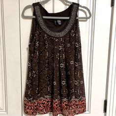 Purchased At Dillard’s. New Direction Brand. Never Worn. Beautiful Flowing Sleeveless Top With Wooden Beaded Neckline. Lined. Xl. Bohemian Sleeveless Beaded Tops, Bohemian Beaded Sleeveless Top, Brown Oval Beaded Hand-strung Necklaces, Affordable Hand-strung Brown Beaded Necklaces, Bohemian Beaded V-neck Top, Brown Bohemian V-neck Top, Brown Multi-strand Necklace With Polished Beads, Beaded Neckline, New Directions