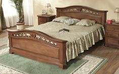 a wooden bed sitting on top of a hard wood floor next to a dresser and mirror