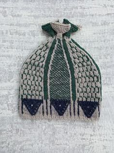 a green and white knitted hat on top of snow