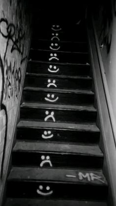 the stairs are covered in graffiti and have been painted with white letters on them to spell out their names