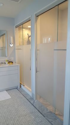 a bathroom with a walk in shower next to a sink