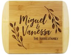 a bamboo cutting board with the words miguel and vanessa on it's side