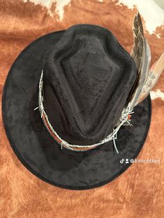 ⭐️⭐️⭐️INTRODUCING: ⭐️⭐️⭐️ CADILLAC COWBOY PLATINUM COLLECTION- RUIDOSO Put a little style in your stride and a hat on your head. Our hats are not just an accessory, they're an attitude. Embrace the fun, the flair, and the endless possibilities. #HatYourHeartOut #CustomHats #Texasstyle #cadillachats https://Cadillachats.com BRAND NEW STYLE!! Arrowhead SHAPED CROWN- BE THE FIRST TO HAVE ONE OF THESE SUPER CUTE STYLE HATS! Black hat, with a leather   band, leather barbed wire band and a custom painted feather along  with various feathers, shotgun shell pin and a rhinestone chain wrap.  ⭐️⭐️ONLY ONE AVAILABLE!⭐️⭐️ This is a Gorgeous hat! One size fits most! Hand wash only, lint brush for dusting Western Style Costume Hats With Short Brim, Adjustable Black Mini Hats For Western-themed Events, Country Style Black Hat For Festival, Black Country Style Hat For Festivals, Bohemian Black Hat For Western-themed Events, Black Mini Hats With Short Brim For Rodeo, Black Mini Hat With Short Brim For Rodeo, Black Country Style Fedora For Festivals, Custom Black Hat For Festival