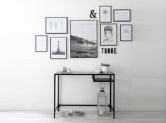 a black and white desk with pictures on the wall