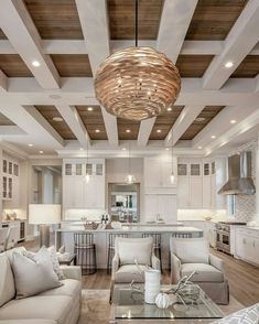 a living room filled with furniture and a large chandelier hanging from the ceiling