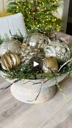 a bowl filled with ornaments on top of a wooden table