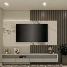 a living room with a large flat screen tv mounted to the side of it's wall