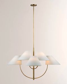 a chandelier with five shades of white on the bottom and one light fixture