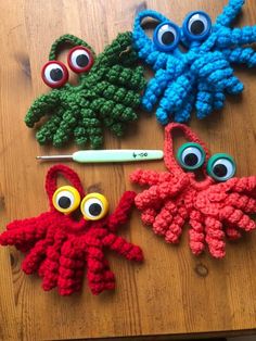 three crocheted octopus ornaments with googly eyes and one eyeball on it