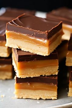 chocolate and peanut butter bars stacked on top of each other in a pile, ready to be eaten