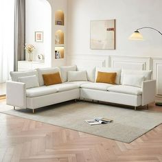 a white couch sitting on top of a hard wood floor