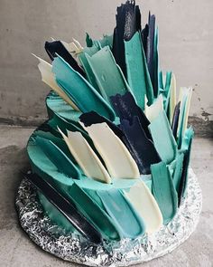 a cake that has been decorated with blue and white icing on top of it