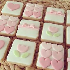 decorated cookies in the shape of hearts on a wicker basket