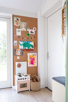 a child's play room with an animal theme on the cork board and toys