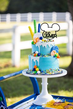 a mickey mouse cake on a blue table