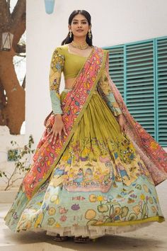 Green attached cancan lehenga with women on a boat in a village kalamkari hand painted patterns. Paired with padded green blouse embroidered with glass beads and pink hand painted dupatta with contrast border. - Aza Fashions Painted Lehenga, Painted Dupatta, Mithila Palkar, Cape Lehenga, Cancan Lehenga, Kurta Lehenga, Lehenga Pattern, Painted Patterns, Diana Penty