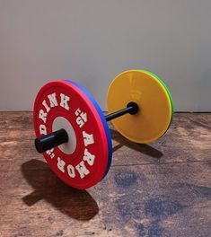 a pair of colorful dumbs sitting on top of a wooden floor