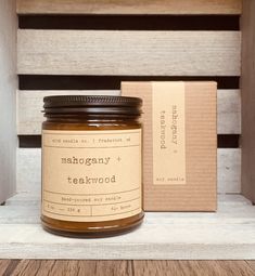 a jar of teakwood sits on a shelf next to a box