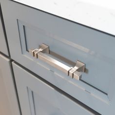 a close up of two drawers with handles on each drawer and one door handle is open