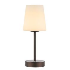 a table lamp with a white shade on it's side and a black base