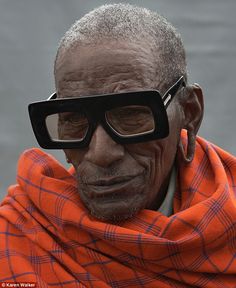 an old man wearing glasses and a scarf