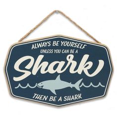 PRICES MAY VARY. Open Road Brands Official product: Live your best sharky life with this captivating and cool wall decor! Bursting with beachy charm, this sign is sure to make a splash. Fun Vintage Sign: With text that reads, "Always be yourself unless you can be a shark - then be a shark," a blue and white color palette, and a shark silhouette, this wall art is as fun as can be. Material: This eye-catching decor is made of lightweight, yet durable MDF, and it features a rope for quick and easy Shark Theme Room, Shark Nursery Theme, Shark Themed Bedroom, Shark Nursery, Nautical Room Decor, Shark Sign, Shark Room, Underwater Room, Coastal Chic Decor