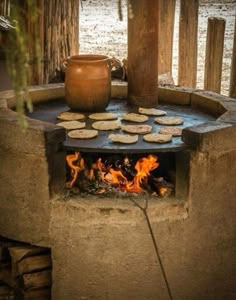 an open fire pit with food cooking in it