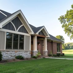 a large house with lots of windows in the front yard