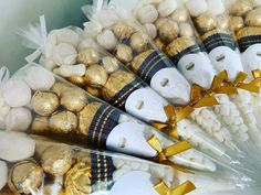 chocolates wrapped in cellophane and tied with gold ribbon are arranged on top of each other