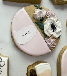 decorated cookies with flowers on them sitting next to cookie cutters and other decorative items