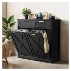 a black cabinet with two drawers and some pictures on top