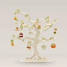 a figurine of a tree with many ornaments hanging from it's branches