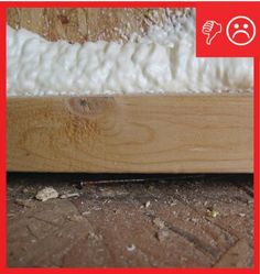 a close up of a wood floor with white foam on it and a red frame