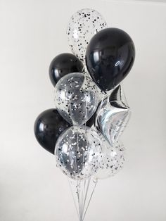 black and white balloons with silver confetti on them