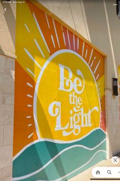 an advertisement on the side of a building that says be the light