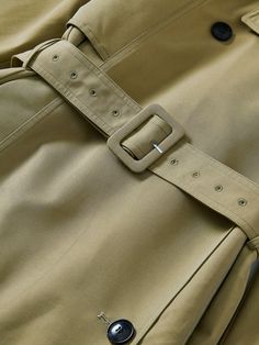 Details: Well-tuned trench coat in green khaki tone Waistband design allows for free waist cinching and a slight A-line hemline. The back panel is three-dimensional and strong, with a woven label design. Classic lapel Materials & Care: Cotton 55.6% Polyester 44.4%; Lining 1: Cotton 100%; Lining 2 Polyester 100% Hand wash | Dry clean Do not bleach Size & Fit: Model is 5'7", Bust 32, Waist 24, Hips 35, wearing a size S Item #: IN1OW03 Beige Belted Spring Outerwear, Spring Beige Outerwear With Belt Detail, Beige Belted Outerwear For Spring, Khaki Belted Gabardine Outerwear, Khaki Gabardine Belted Outerwear, Khaki Belted Utility Outerwear, Woven Label Design, Waistband Design