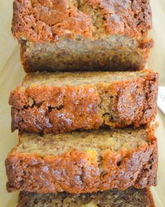 three slices of banana bread sitting on top of a cutting board