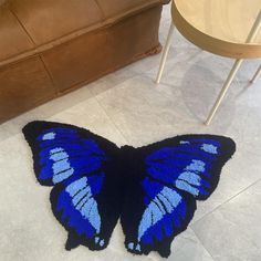 a blue butterfly rug sitting on the floor