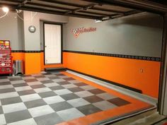 an orange and black checkered floor in a garage with two vending machines on each side