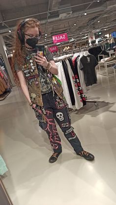 Non-binary person in crust patches pants and battle vest makes a mirror selfie in a store Battle Pants, Punk Vest Outfit, Battle Vest Outfit, Punk Overalls, Patch Pants Ideas, Crust Pants Patch Ideas, Crust Punk Style, Eco Punk