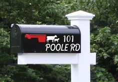 a mailbox with the word pool rd painted on it in front of some trees