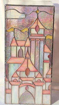 a stained glass window with a castle on it