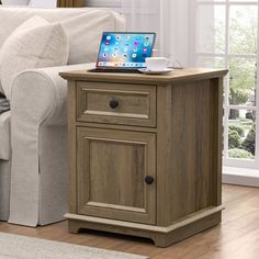 a small wooden table with a laptop on it