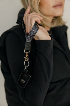 Smile Squad Wrist Lanyard Hang tight to your possessions with the Smile Squad wrist lanyard. It is perfect to keep track of your keys and other accessories. Complete the look with the coordinating Smile Squad case and Apple watch band and you're good to go! Design: Beige smiley faces on a black backgroundStrap Dimensions: 3.7 inches long, .75 inches wide Lanyard Photoshoot, Wrist Lanyard, Smiley Faces, The Smile, Post Ideas, Blankets For Sale, Apple Watch Band, Smiley Face, Apple Watch Bands