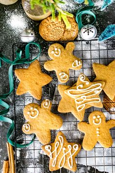 Gingerbread cookies with icing on a cooling rack with ribbon.