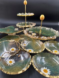 several green plates with yellow and white flowers on them