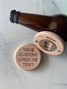 two bottle openers sitting on top of a table next to a brown beer bottle